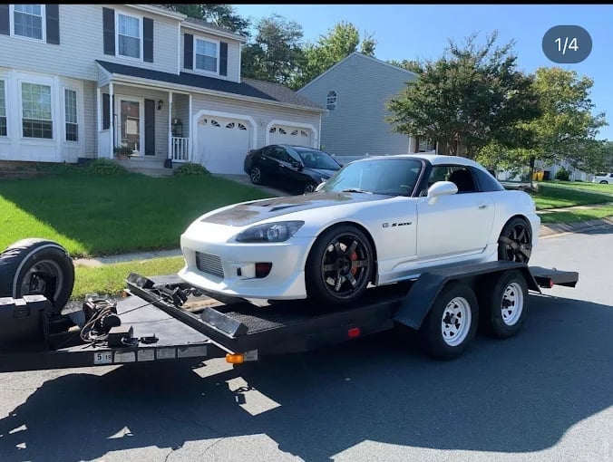White sports car loaded on a tow trailer